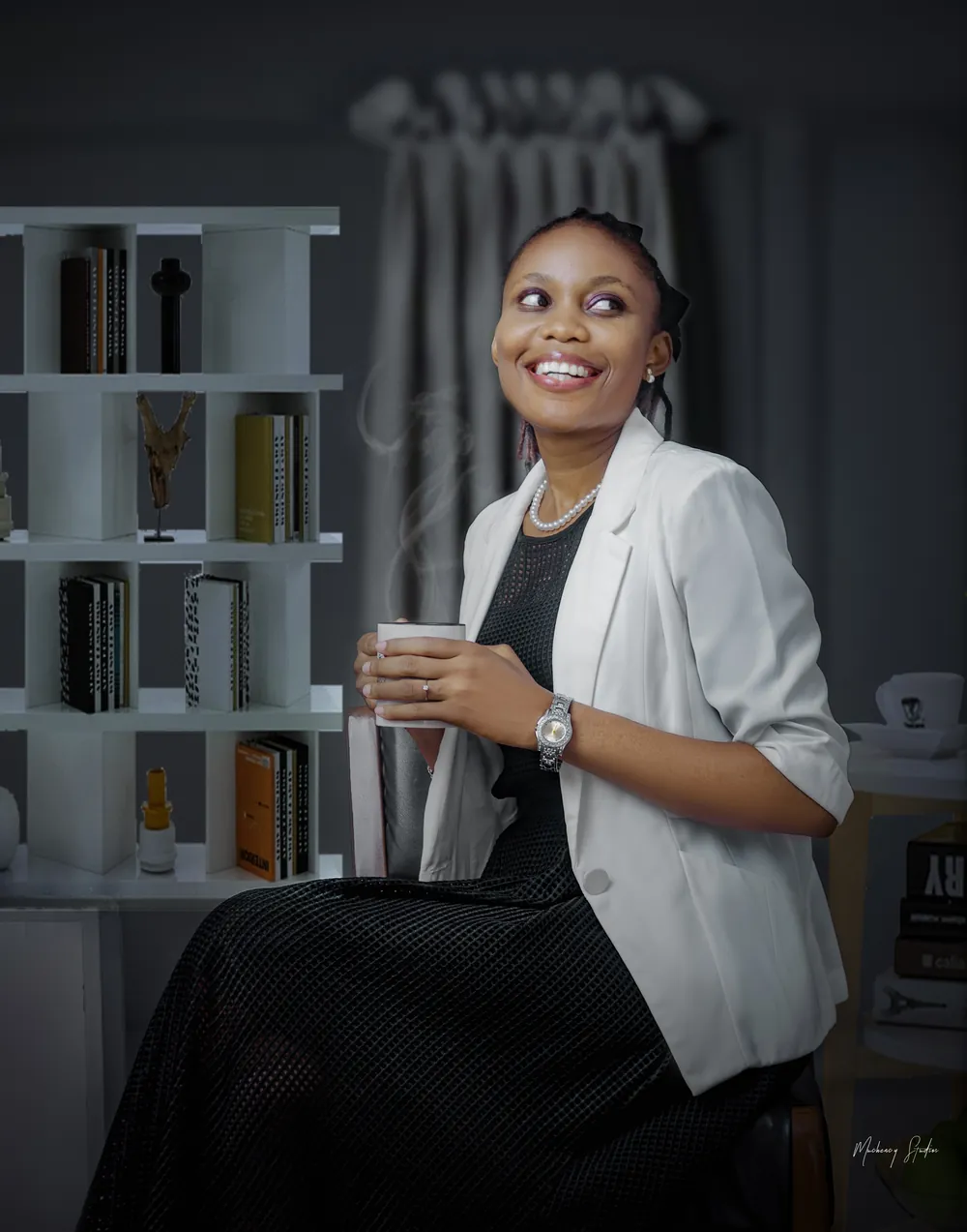 Dina Yerima-Avazi smiling, a steaming mug of coffee in her hands