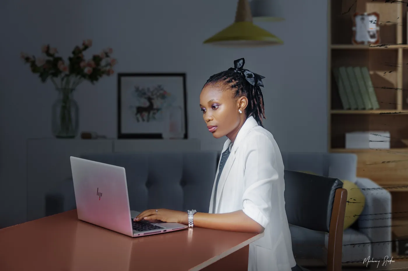 Dina Yerima-Avazi typing at a laptop, absorbed in her work